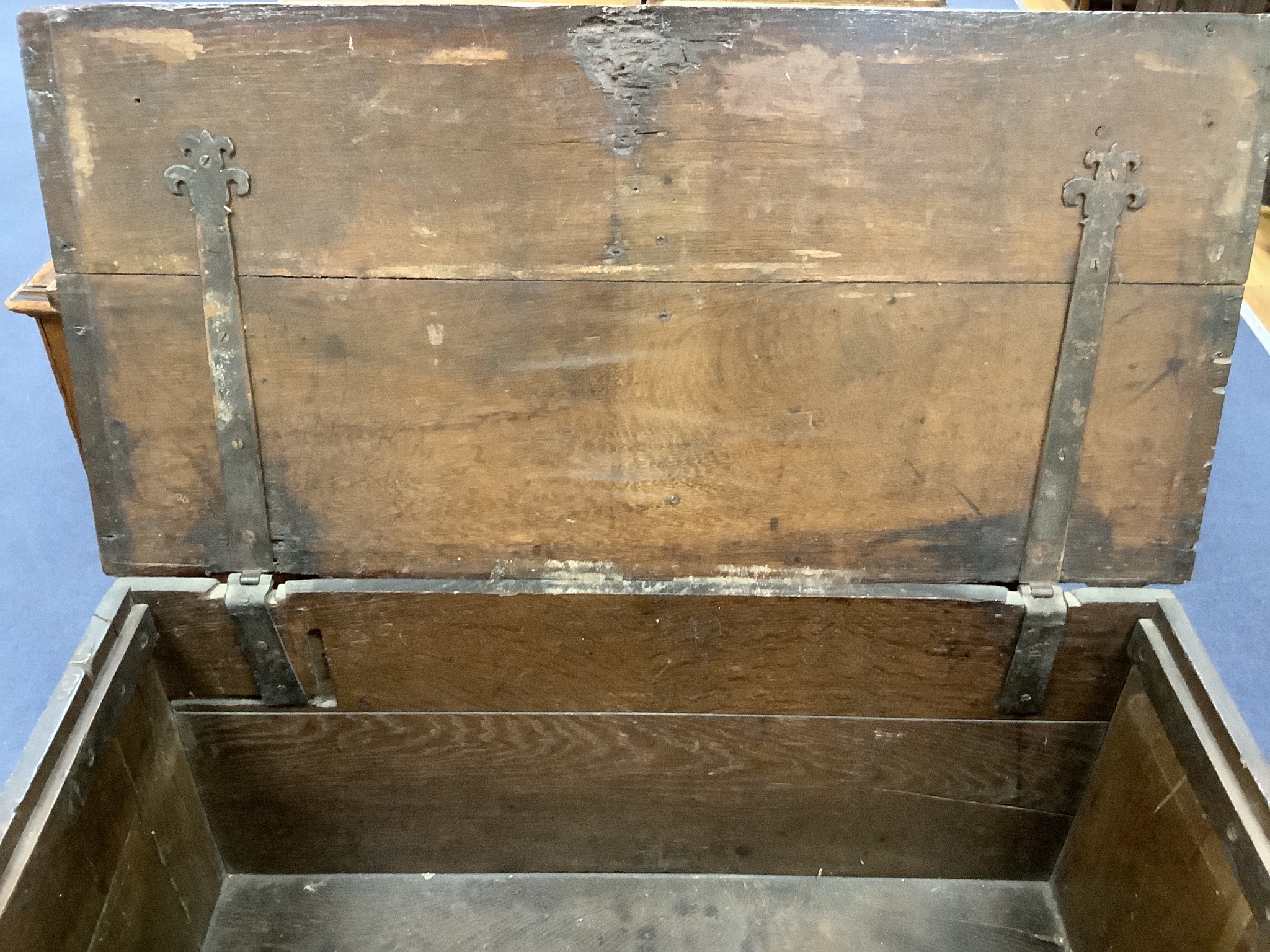 A 17th century carved boarded and panelled oak chest with rectangular moulded top, length 97cm, depth 48cm, height 64cm